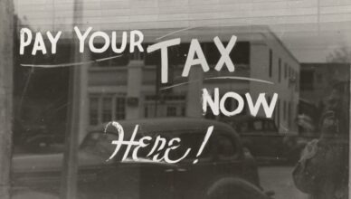 a sign that says pay your tax now here